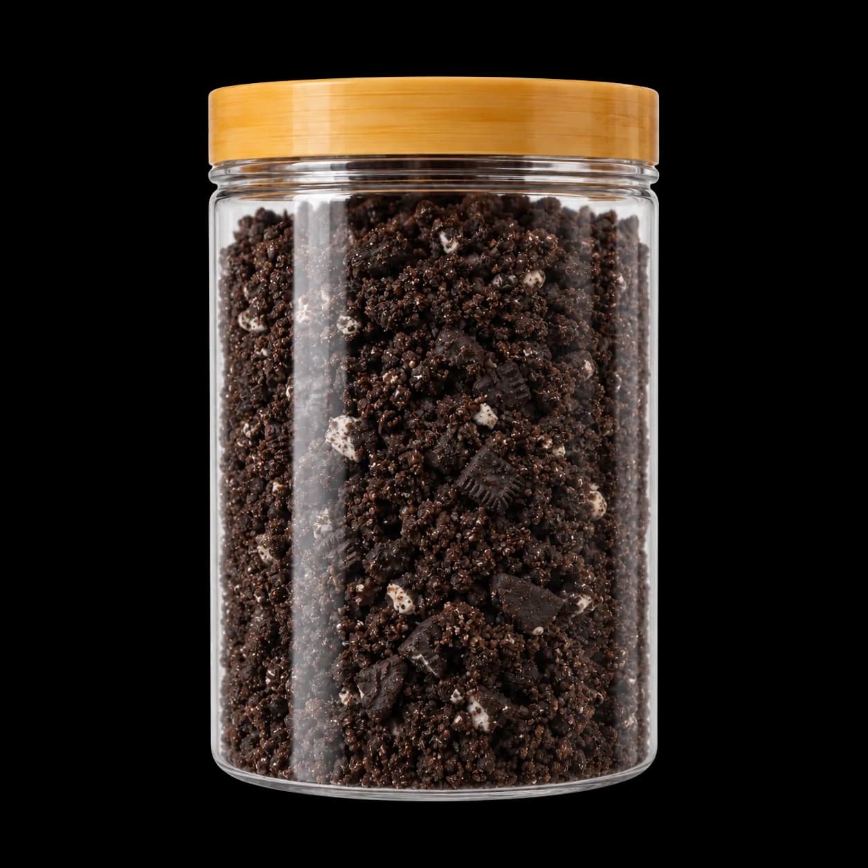 Glass jar of dark sandwich cookie crumbs with white cream pieces and a bamboo lid