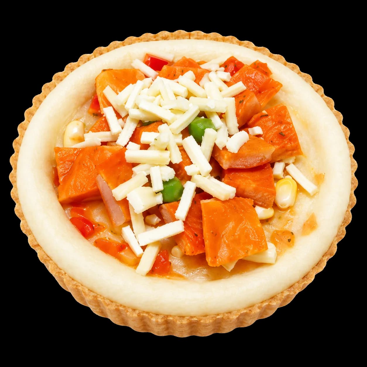 Unbaked pizza dough in a fluted shell, topped with vegetables and shredded cheese